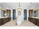Bright bathroom featuring dual sinks, a standalone tub, and a walk-in shower at 16365 Redington Dr, Redington Beach, FL 33708