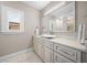Bathroom featuring white vanity and sink, window, and large mirror at 16365 Redington Dr, Redington Beach, FL 33708
