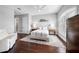 Neutral bedroom with hardwood floors, white trim, and en suite bathroom at 16365 Redington Dr, Redington Beach, FL 33708