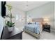 Serene bedroom with light blue walls, white plank accent wall, and a queen bed with striped bedding at 16365 Redington Dr, Redington Beach, FL 33708