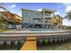 Beautiful waterfront home featuring a private pool, dock, and multiple balconies for enjoying the views at 16365 Redington Dr, Redington Beach, FL 33708
