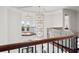 Grand foyer with custom lighting, dark wood railings, and entry way with transoms above the door at 16365 Redington Dr, Redington Beach, FL 33708
