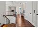 Upstairs hallway features wood floors, white trim, and archways that lead to other rooms at 16365 Redington Dr, Redington Beach, FL 33708
