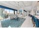 Open living room with beautiful water views, coffered ceilings and luxury decor at 16365 Redington Dr, Redington Beach, FL 33708