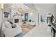 Bright living room boasting a fireplace, modern furniture, and sleek tile flooring throughout at 16365 Redington Dr, Redington Beach, FL 33708
