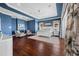 Stylish main bedroom with dark wood floors, blue walls, and water view with balcony access at 16365 Redington Dr, Redington Beach, FL 33708