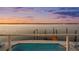 Inviting swimming pool with waterfront views, complemented by a private dock and serene surroundings at 16365 Redington Dr, Redington Beach, FL 33708