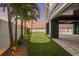 Backyard putting green and outdoor patio area with waterfront views and palm trees at 16365 Redington Dr, Redington Beach, FL 33708