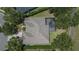An aerial view of a home featuring a screened-in pool and a well-maintained roof at 16367 Ashington Park Dr, Tampa, FL 33647