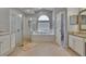 Bright bathroom featuring a soaking tub, walk-in shower, and vanity with granite countertop at 16367 Ashington Park Dr, Tampa, FL 33647