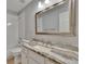 Bathroom featuring granite counter, large mirror, and shower-tub combination at 16367 Ashington Park Dr, Tampa, FL 33647
