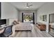 Bright bedroom featuring a ceiling fan, TV, mirror, work area, and sliding door access to the outdoors at 16367 Ashington Park Dr, Tampa, FL 33647