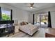 Bright bedroom featuring a ceiling fan, an area for work, and sliding door access to the outdoor living space at 16367 Ashington Park Dr, Tampa, FL 33647