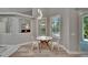 Bright breakfast nook with modern lighting fixture and view to the backyard at 16367 Ashington Park Dr, Tampa, FL 33647