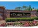 Elegant Tampa Palms brick community sign surrounded by lush landscaping and vibrant flowers at 16367 Ashington Park Dr, Tampa, FL 33647