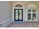Welcoming entrance with seating and decorative features creating a charming curb appeal at 16367 Ashington Park Dr, Tampa, FL 33647