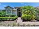 Inviting entrance with a well-manicured walkway and beautiful landscaping leading to the front door at 16367 Ashington Park Dr, Tampa, FL 33647