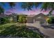 Charming single-story home showcasing a three-car garage, manicured lawn, and lush landscaping at 16367 Ashington Park Dr, Tampa, FL 33647
