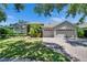 Charming single-story home with lush landscaping, manicured lawn, and inviting curb appeal at 16367 Ashington Park Dr, Tampa, FL 33647