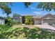 Charming single-story home with lush landscaping, manicured lawn, and inviting curb appeal at 16367 Ashington Park Dr, Tampa, FL 33647