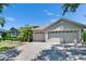 Spacious three-car garage and beautiful landscaping enhance curb appeal at 16367 Ashington Park Dr, Tampa, FL 33647