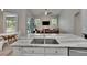 Kitchen island with marble countertop and open view of the living room area at 16367 Ashington Park Dr, Tampa, FL 33647