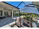 Large screened lanai with stone flooring, fish pond, and walking bridge at 16367 Ashington Park Dr, Tampa, FL 33647