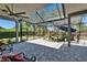 Covered lanai with brick flooring and view of the yard and garden at 16367 Ashington Park Dr, Tampa, FL 33647