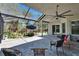 Beautiful covered lanai with brick flooring, garden, and outdoor seating at 16367 Ashington Park Dr, Tampa, FL 33647