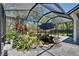 Beautiful screened in lanai with a fish pond, and a walkway at 16367 Ashington Park Dr, Tampa, FL 33647