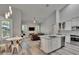 Open-concept living space with a kitchen island, modern lighting, and comfortable seating at 16367 Ashington Park Dr, Tampa, FL 33647