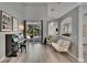 Bright living room with piano, comfortable seating, and sliding glass doors leading to outdoor space at 16367 Ashington Park Dr, Tampa, FL 33647