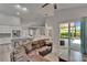 Open concept living room with tile floors, view to kitchen, breakfast nook, and lanai at 16367 Ashington Park Dr, Tampa, FL 33647