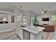 Bright living room with modern furnishings, kitchen island, and vaulted ceilings at 16367 Ashington Park Dr, Tampa, FL 33647
