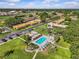 Aerial view of a community with a pool, clubhouse, and well-maintained landscaping at 1701 Pinehurst Rd # 9G, Dunedin, FL 34698