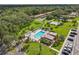 Aerial view of community pool with lounge area, lush landscaping, and well-maintained grounds at 1701 Pinehurst Rd # 9G, Dunedin, FL 34698