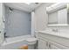 Tiled bathroom featuring a shower-tub combo, a white vanity, and modern fixtures at 1701 Pinehurst Rd # 9G, Dunedin, FL 34698