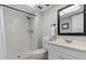 Bathroom featuring a sleek, frameless shower and a modern vanity with a rectangular mirror at 1701 Pinehurst Rd # 9G, Dunedin, FL 34698