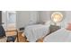 Bright bedroom with two twin beds, modern furnishings, and an ensuite bathroom at 1701 Pinehurst Rd # 9G, Dunedin, FL 34698