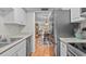 Modern kitchen leading into a dining area, showcasing stainless steel appliances and granite countertops at 1701 Pinehurst Rd # 9G, Dunedin, FL 34698