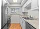 Well-lit kitchen featuring ample counter space, stainless steel appliances, and a window view at 1701 Pinehurst Rd # 9G, Dunedin, FL 34698