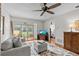 Cozy living room with a comfortable sofa, TV, and sliding glass doors to the outside at 1701 Pinehurst Rd # 9G, Dunedin, FL 34698