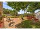 Serene backyard featuring a brick patio, mature trees, and a variety of plants and garden decor at 1707 Hibiscus S Cir, Oldsmar, FL 34677