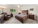 Bedroom with hardwood furniture, comfy recliner, and neutral paint scheme that adds to the charm at 1707 Hibiscus S Cir, Oldsmar, FL 34677