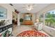 Bright Florida Room with tile floors, large windows, and access to the backyard at 1707 Hibiscus S Cir, Oldsmar, FL 34677