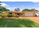 Charming single-story home with a lush green lawn and well-manicured landscaping in a desirable neighborhood at 1707 Hibiscus S Cir, Oldsmar, FL 34677
