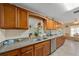 Kitchen featuring granite countertops, stainless steel appliances, and wood cabinets at 1707 Hibiscus S Cir, Oldsmar, FL 34677