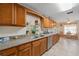 Well-lit kitchen featuring stainless steel appliances, granite countertops, and wood cabinets at 1707 Hibiscus S Cir, Oldsmar, FL 34677