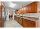 Galley kitchen with granite countertops, stainless steel appliances and abundant wood cabinetry at 1707 Hibiscus S Cir, Oldsmar, FL 34677