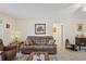 Cozy living room with tile floors, comfortable sofa, accent furniture, and warm lighting at 1707 Hibiscus S Cir, Oldsmar, FL 34677